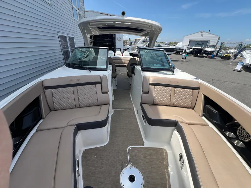 Slide: The Image of 2017 Sea Ray SLX 350 OB boat interior with beige seating and open deck. - 20