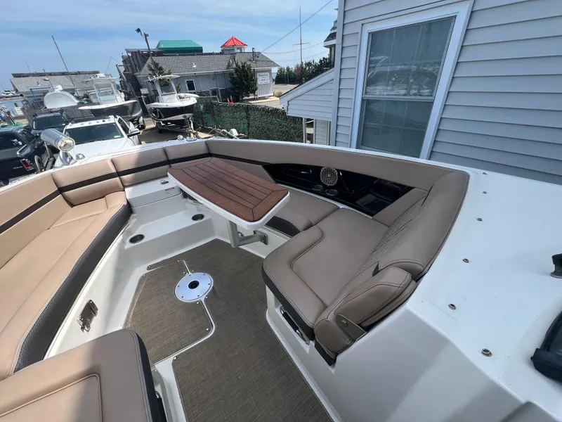 Slide: The Image of 2017 Sea Ray SLX 350 OB boat interior with beige seating and modern design. - 22