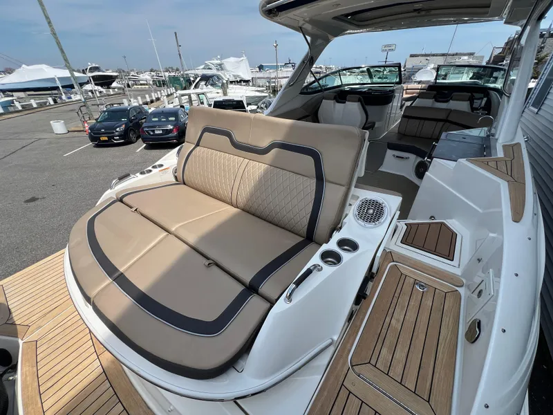 Slide: The Image of 2017 Sea Ray SLX 350 OB luxury boat with spacious seating and elegant design at a marina. - 27