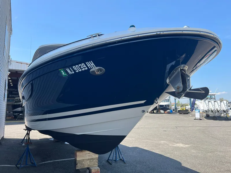 Slide: The Image of 2017 Sea Ray SLX 350 OB boat on stands, blue and white hull, outdoor display. - 33