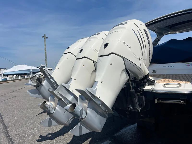 Slide: The Image of 2017 Sea Ray SLX 350 OB with triple outboard engines at a marina. - 38