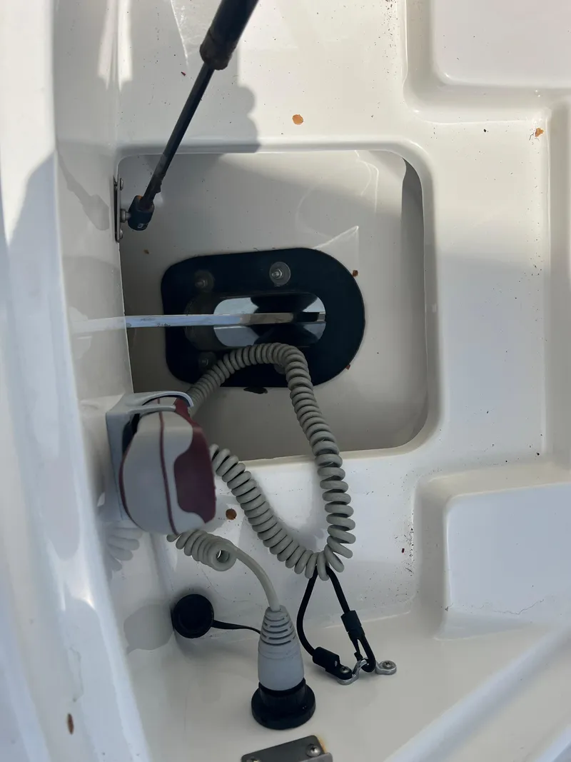 Slide: The Image of 2017 Sea Ray SLX 350 OB boat compartment with coiled cables and hydraulic support. - 43