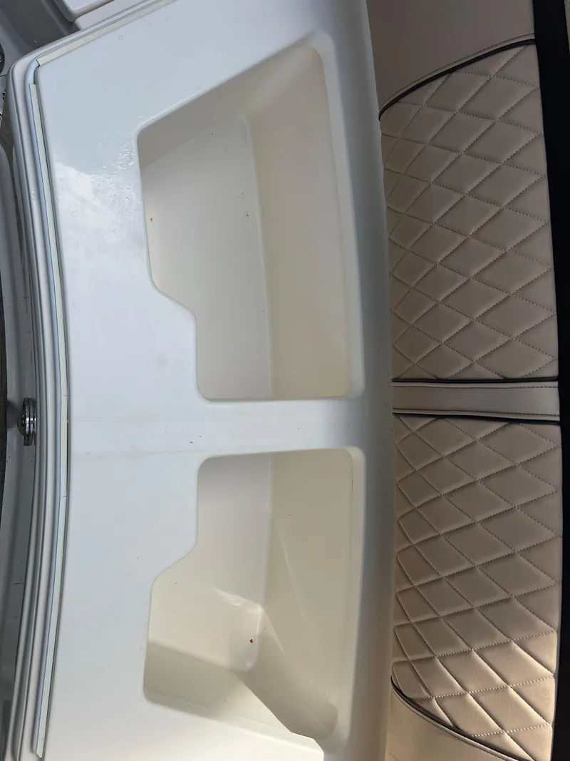 Slide: The Image of 2017 Sea Ray SLX 350 OB boat interior with storage compartments and quilted seating. - 44