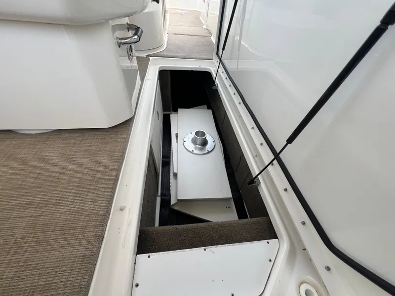 Slide: The Image of 2017 Sea Ray SLX 350 OB storage compartment with open hatch, showcasing interior details. - 46