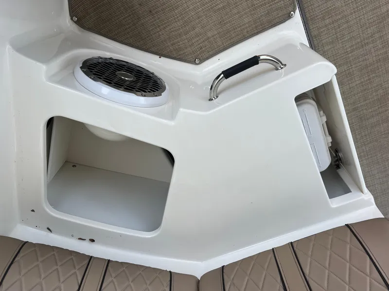 Slide: The Image of 2017 Sea Ray SLX 350 OB interior detail with speaker, handle, and storage compartment. - 48