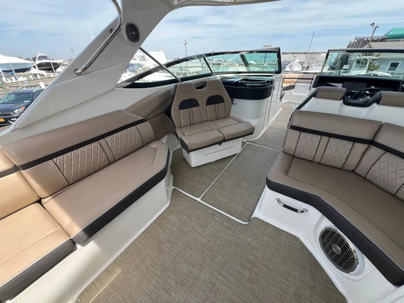 Slide: The Image of 2017 Sea Ray SLX 350 OB boat interior with beige seating and modern design. - 5