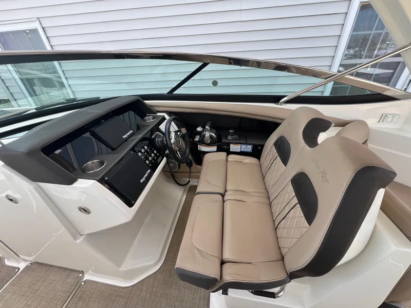 Slide: The Image of 2017 Sea Ray SLX 350 OB cockpit with dual seats and modern dashboard. - 9