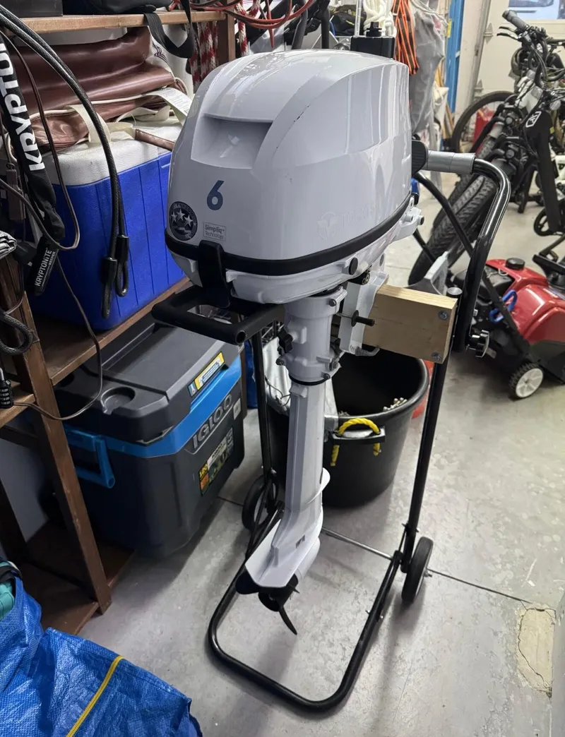 Slide: The Image of 2022 Com-Pac CP 23 Pilothouse outboard motor in a garage setting. - 17