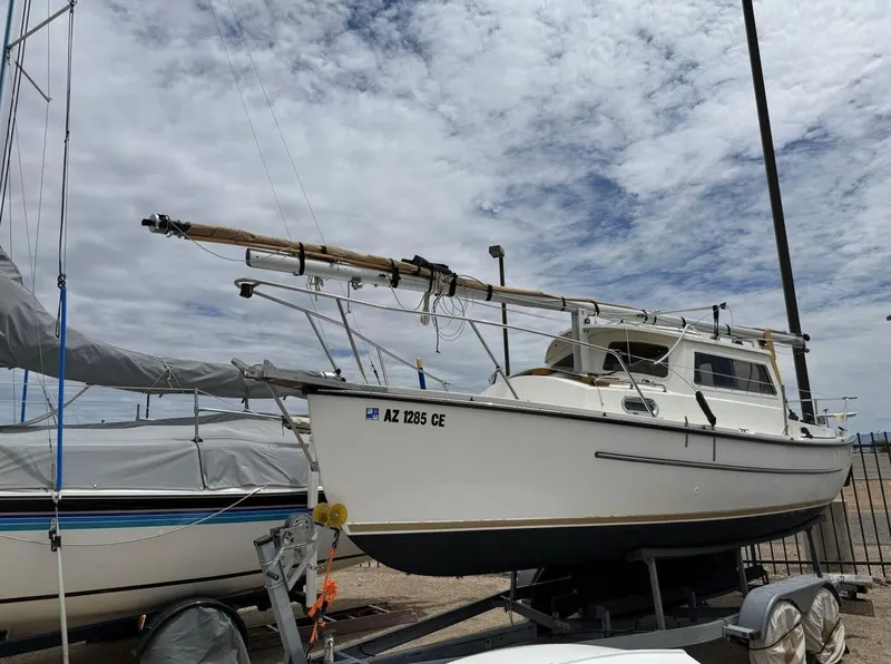 Slide: The Image of 2022 Com-Pac CP 23 Pilothouse sailboat on trailer under cloudy sky. - 3