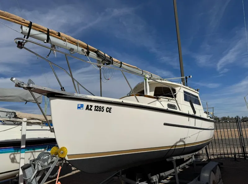 Slide: The Image of 2022 Com-Pac CP 23 Pilothouse sailboat on trailer under clear blue sky. - 4
