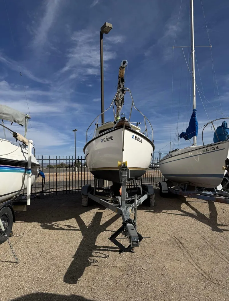 Slide: The Image of 2022 Com-Pac CP 23 Pilothouse sailboat on trailer under clear sky. - 5