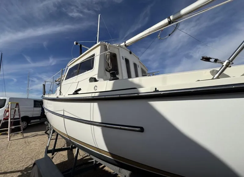 Slide: The Image of 2022 Com-Pac CP 23 Pilothouse sailboat on dry dock under a clear blue sky. - 8