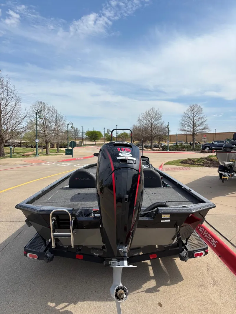 Slide: The Image of 2020 Vexus AVX1880 boat on trailer, parked outdoors under a clear sky. - 4