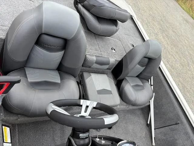 Slide: The Image of 2020 Bass Tracker Pro Team 195 boat interior with gray seating and steering wheel. - 4