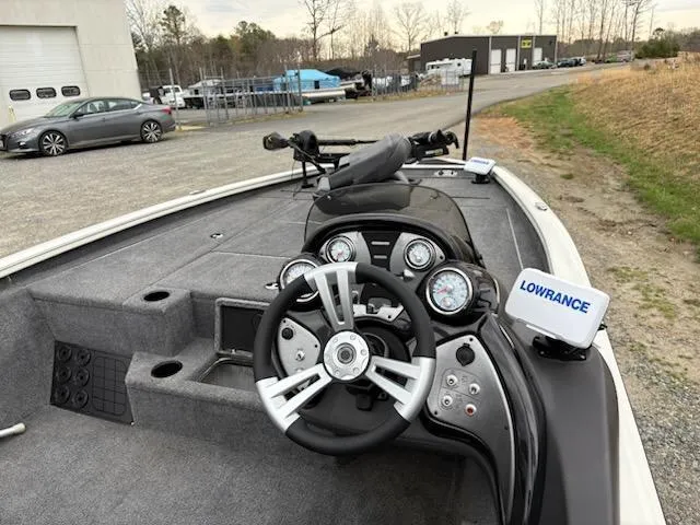 Slide: The Image of 2020 Bass Tracker Pro Team 195 boat interior with steering wheel and Lowrance navigation system. - 5