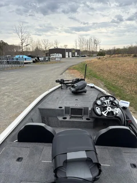 Slide: The Image of 2020 Bass Tracker Pro Team 195 boat with steering console, parked on a gravel path. - 6