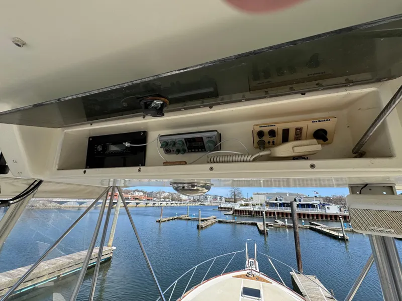 Slide: The Image of 1985 Egg Harbor Convertible boat helm with electronics, overlooking marina and docks. - 11