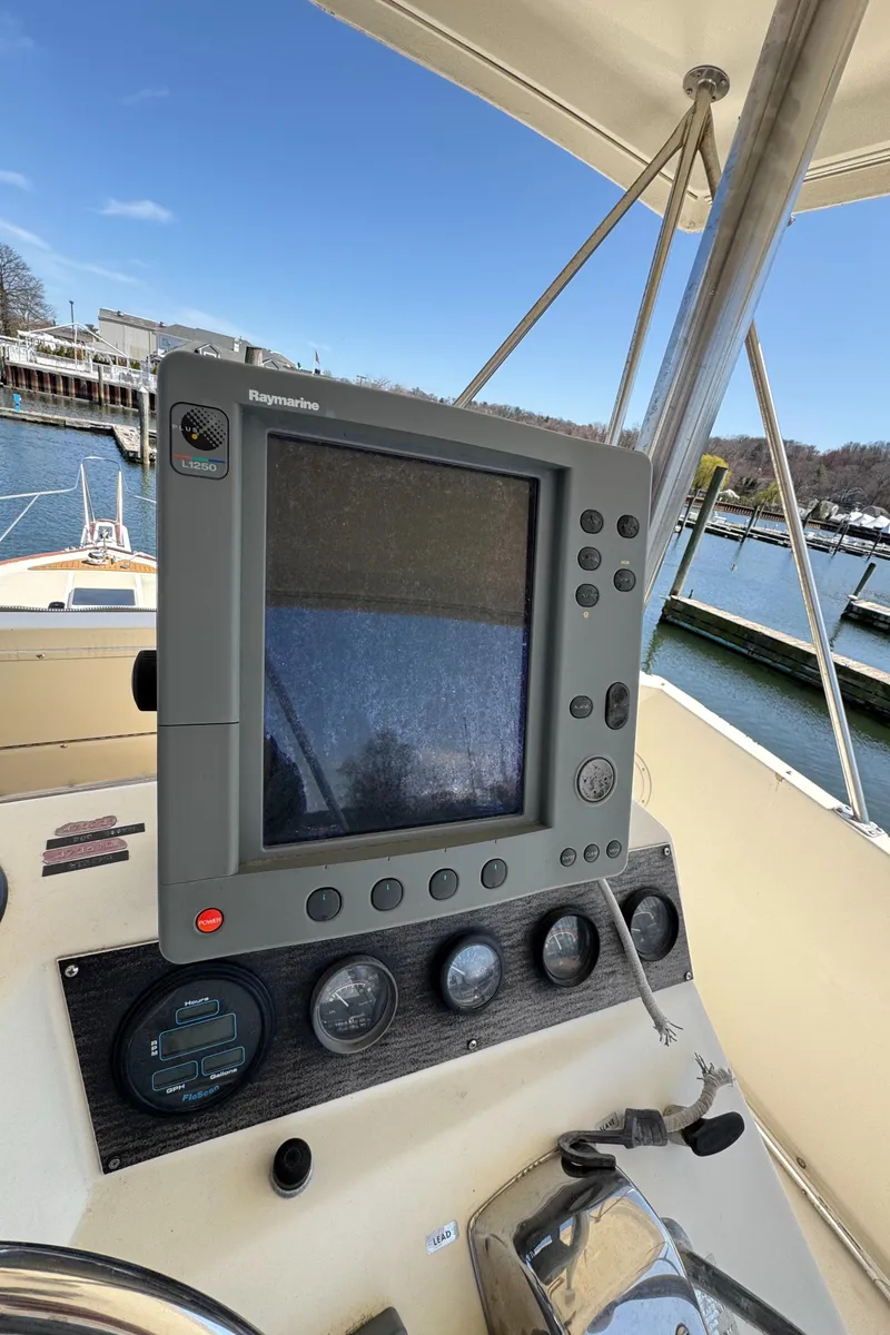Slide: The Image of 1985 Egg Harbor Convertible boat dashboard with navigation equipment and gauges. - 14
