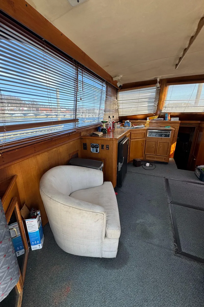 Slide: The Image of 1985 Egg Harbor Convertible interior with chair, windows, and kitchenette. - 17