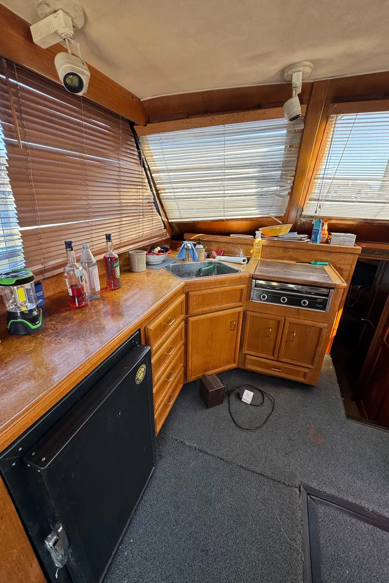 Slide: The Image of 1985 Egg Harbor Convertible yacht interior with wooden cabinetry and appliances. - 19