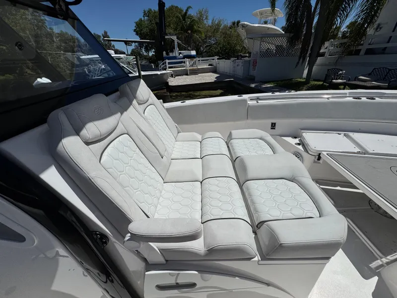 Slide: The Image of Luxurious seating on 2022 Sea Fox 368 Commander boat, featuring plush white upholstery. - 13