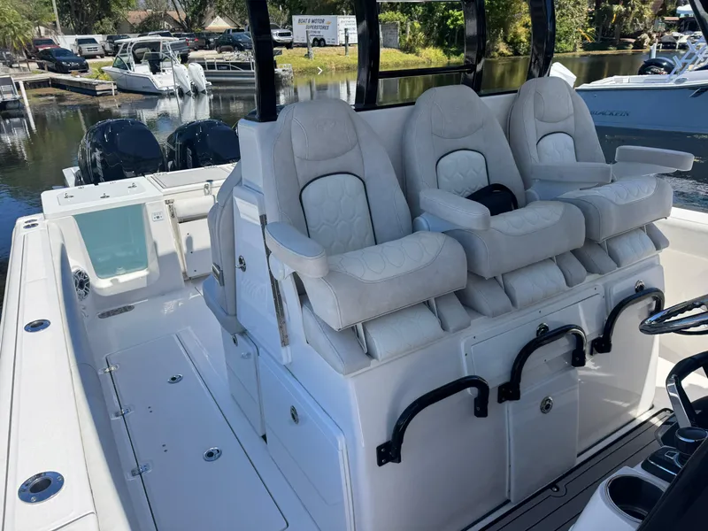 Slide: The Image of 2022 Sea Fox 368 Commander boat with plush seating and dual engines docked by the water. - 17