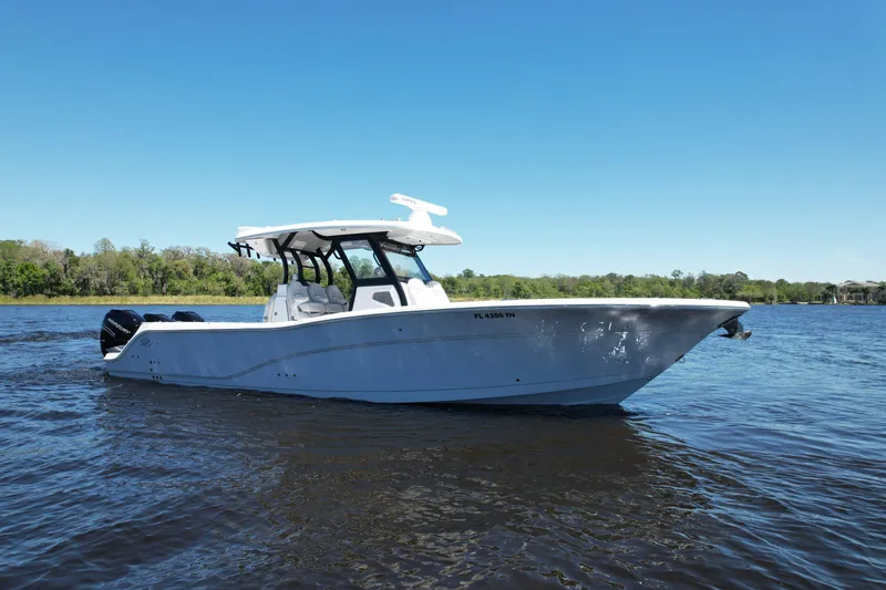Slide: The Image of 2022 Sea Fox 368 Commander boat on calm water under clear blue sky. - 2