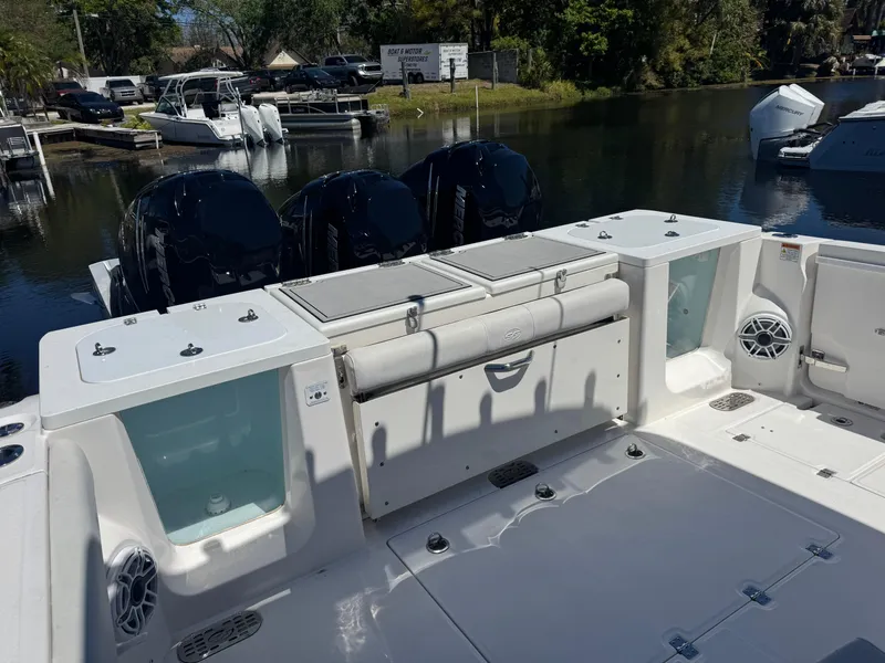 Slide: The Image of 2022 Sea Fox 368 Commander boat with triple engines docked by the water. - 23