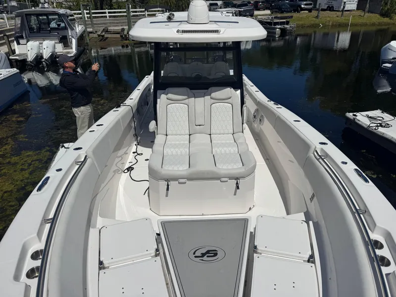 Slide: The Image of 2022 Sea Fox 368 Commander boat with spacious seating and sleek design on calm water. - 29