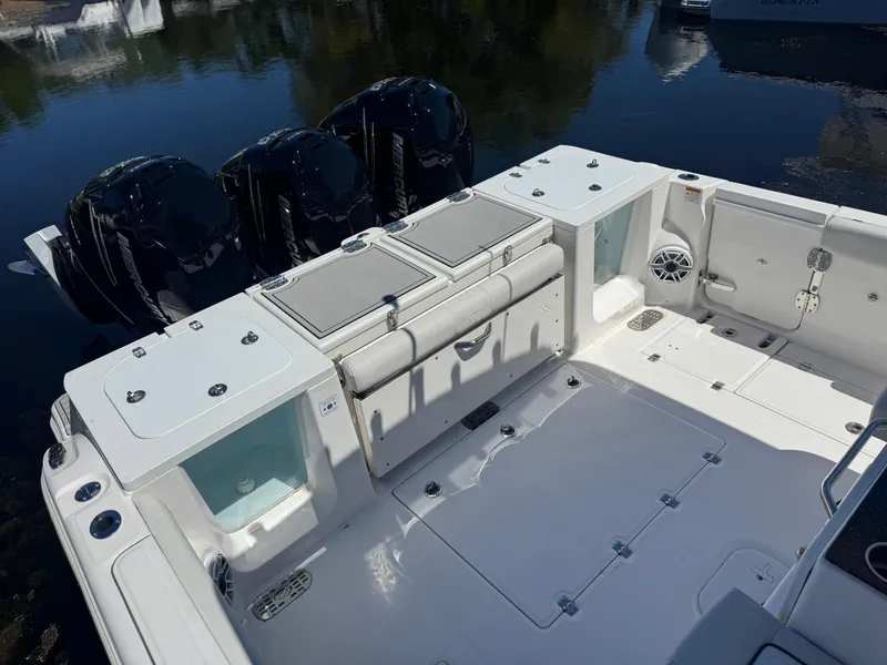 Slide: The Image of 2022 Sea Fox 368 Commander boat deck with triple engines and storage compartments. - 34