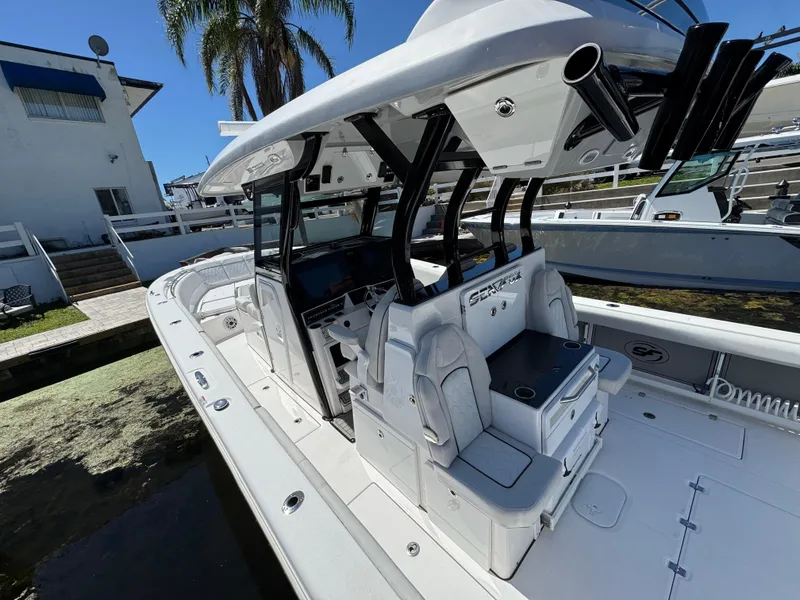 Slide: The Image of 2022 Sea Fox 368 Commander boat with sleek design and modern features docked near a house. - 42