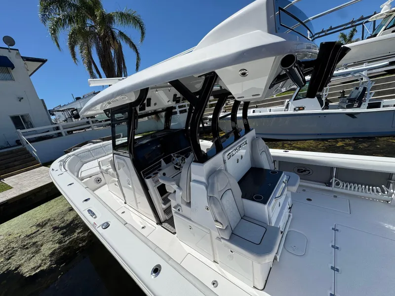 Slide: The Image of 2022 Sea Fox 368 Commander boat with sleek design, docked near palm trees. - 43