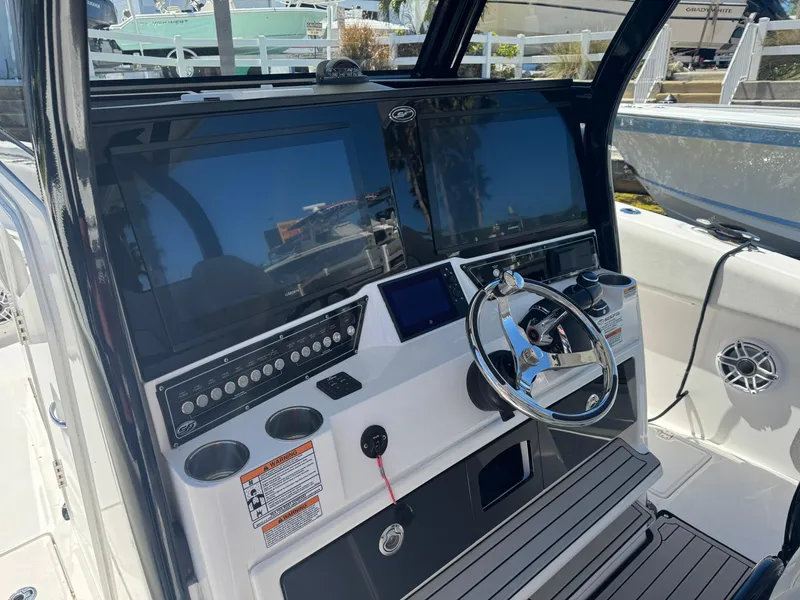 Slide: The Image of 2022 Sea Fox 368 Commander boat dashboard with dual screens and steering wheel. - 44