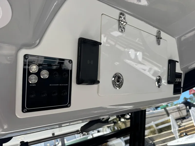Slide: The Image of Control panel of 2022 Sea Fox 368 Commander boat, featuring switches and storage compartment. - 46