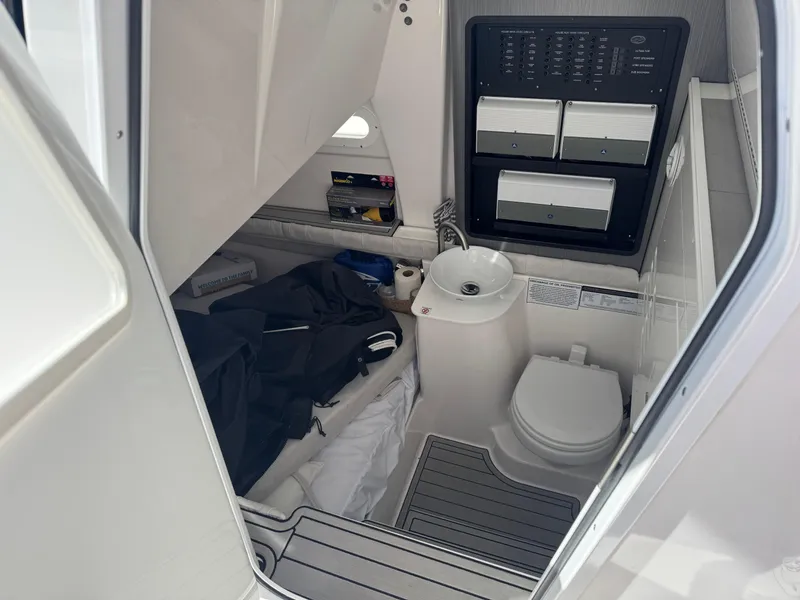 Slide: The Image of Interior of 2022 Sea Fox 368 Commander boat, featuring a compact bathroom with toilet and sink. - 47