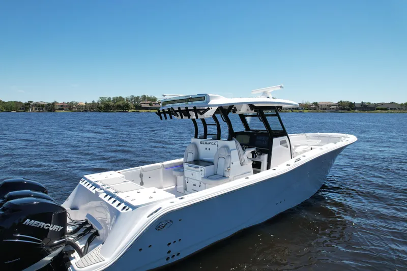 Slide: The Image of 2022 Sea Fox 368 Commander boat on water, featuring sleek design and powerful Mercury engines. - 6