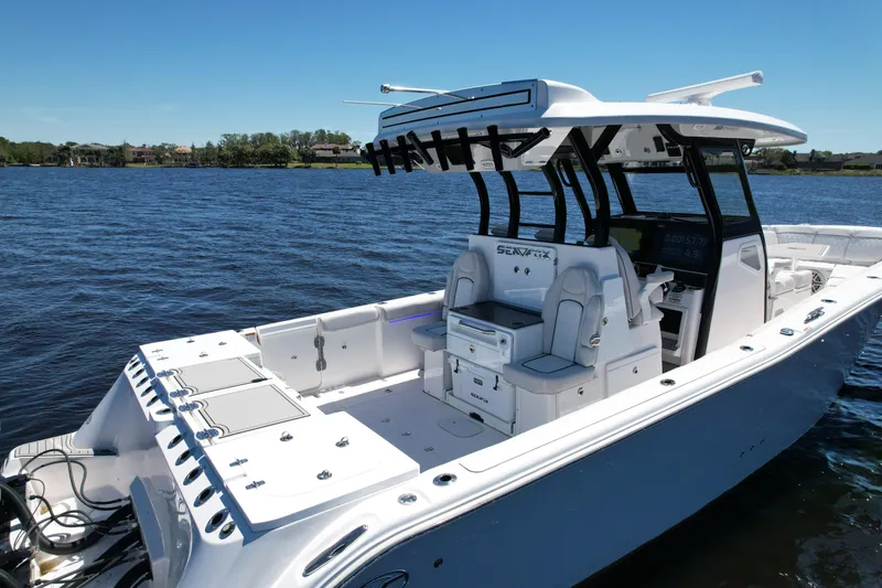 Slide: The Image of 2022 Sea Fox 368 Commander boat on water, featuring spacious deck and modern design. - 7