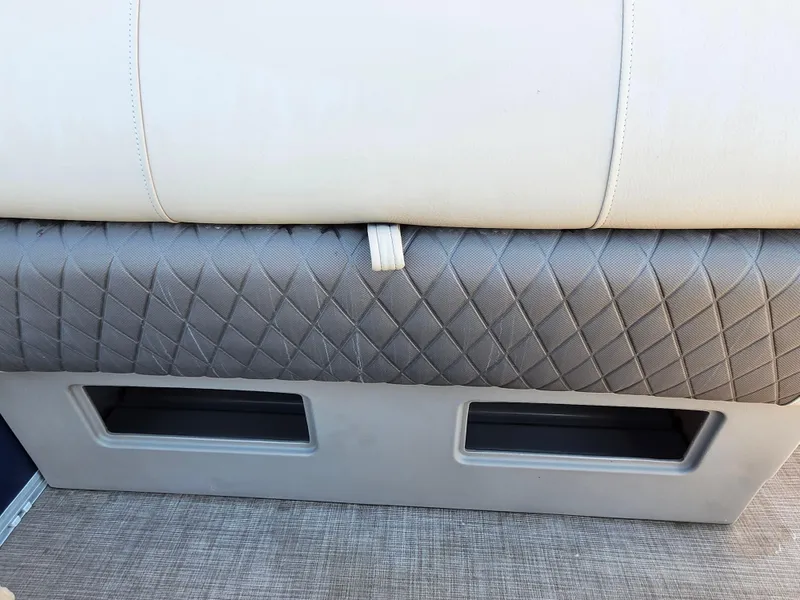 Slide: The Image of 2023 Sun Tracker Fishin' Barge 20 DLX seat with quilted upholstery and storage compartments. - 12