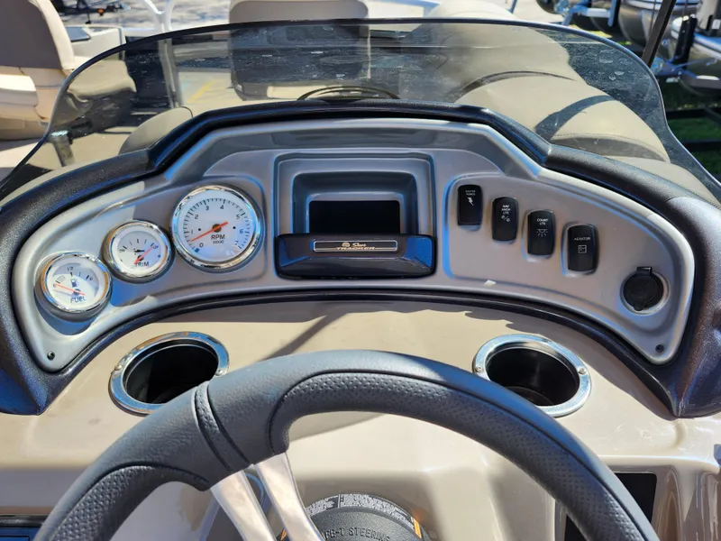 Slide: The Image of 2023 Sun Tracker Fishin' Barge 20 DLX dashboard with gauges and controls. - 15