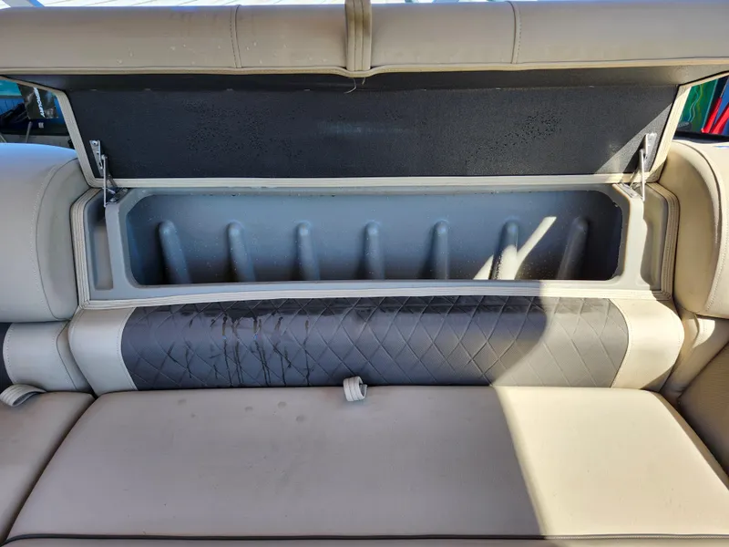 Slide: The Image of 2023 Sun Tracker Fishin' Barge 20 DLX storage compartment with cushioned seating. - 24