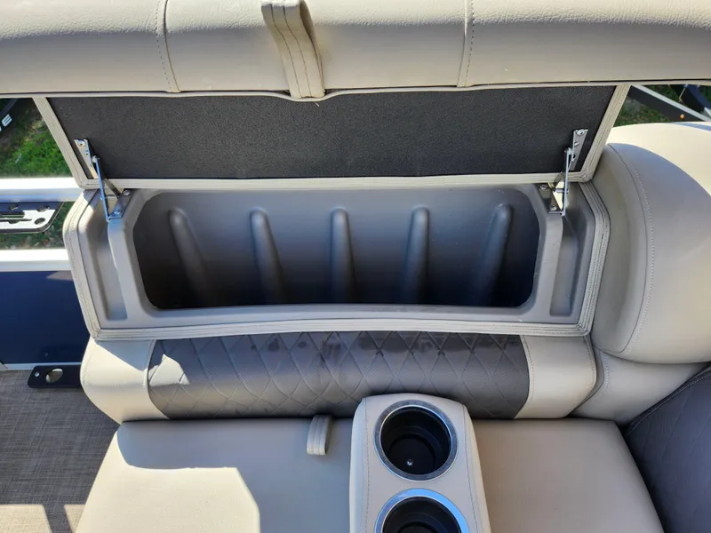 Slide: The Image of 2023 Sun Tracker Fishin' Barge 20 DLX storage compartment with cup holders and cushioned seating. - 29