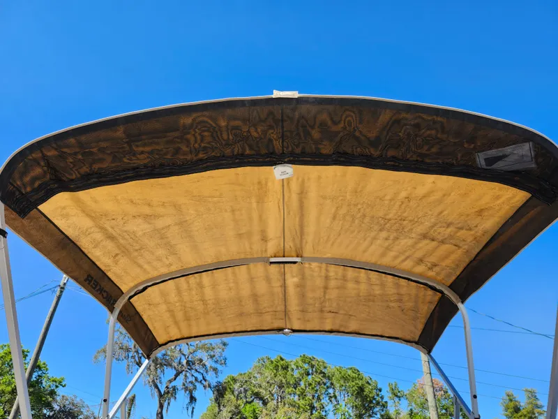 Slide: The Image of 2023 Sun Tracker Fishin' Barge 20 DLX canopy under clear blue sky. - 39