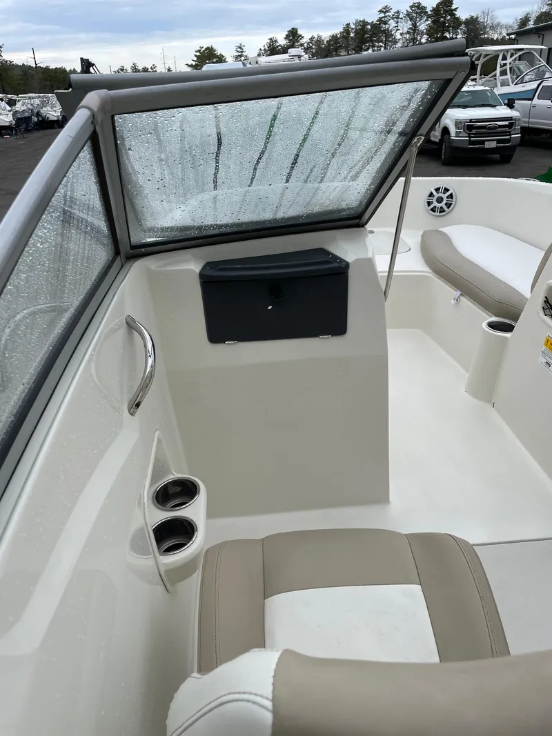 Slide: The Image of 2017 Stingray 191 DC boat interior with wet windshield and seating area. - 13