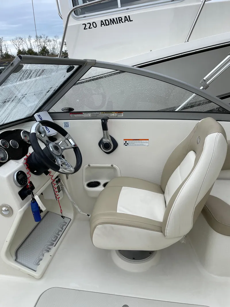 Slide: The Image of 2017 Stingray 191 DC boat interior with steering wheel and captain's seat. - 14