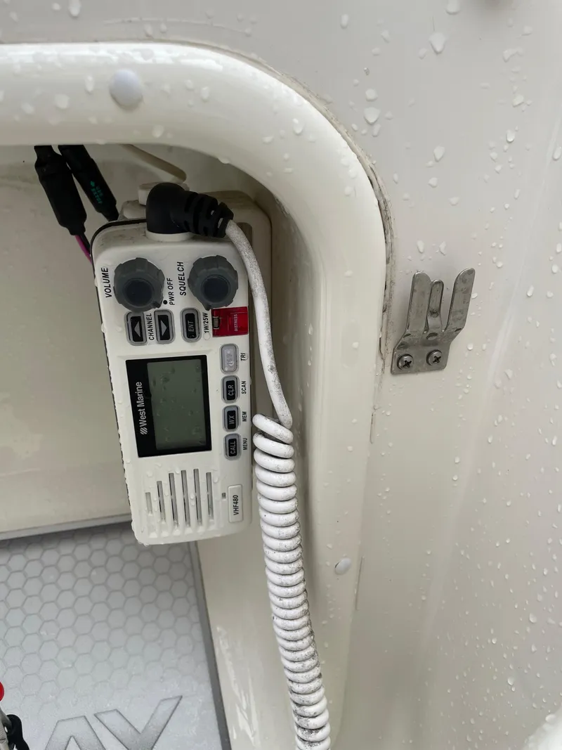 Slide: The Image of VHF marine radio in a 2017 Stingray 191 DC boat, with water droplets visible. - 17