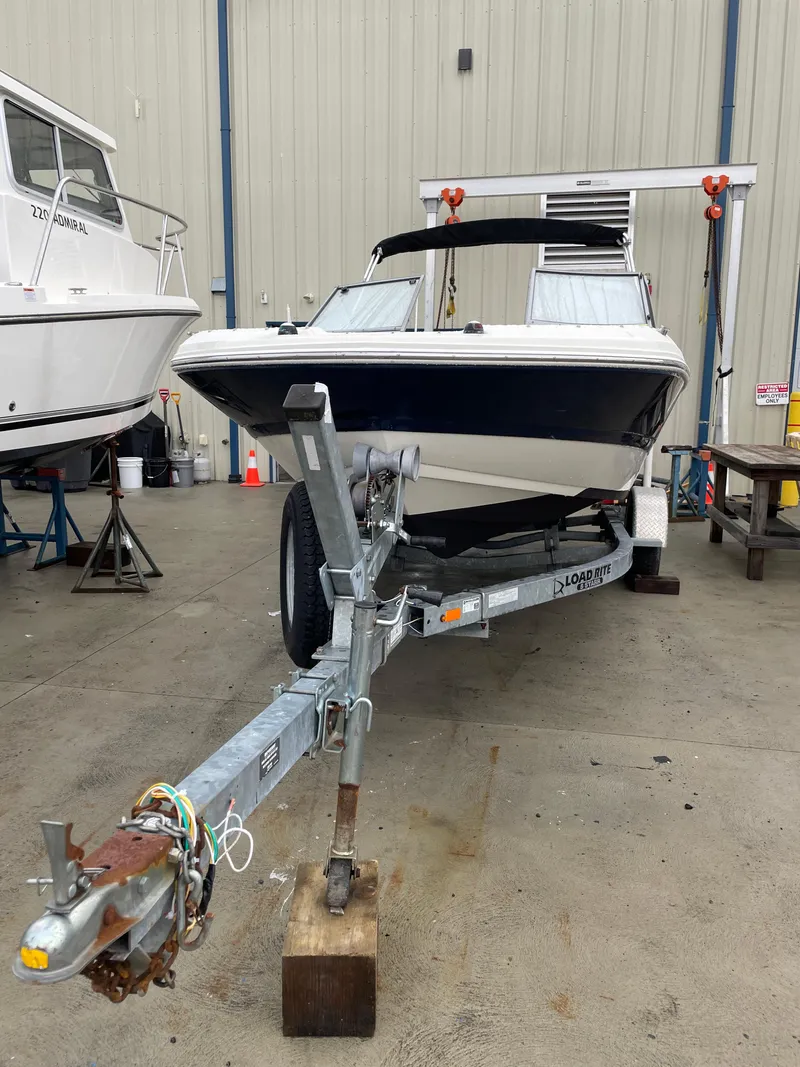 Slide: The Image of 2017 Stingray 191 DC boat on trailer in a storage facility. - 2