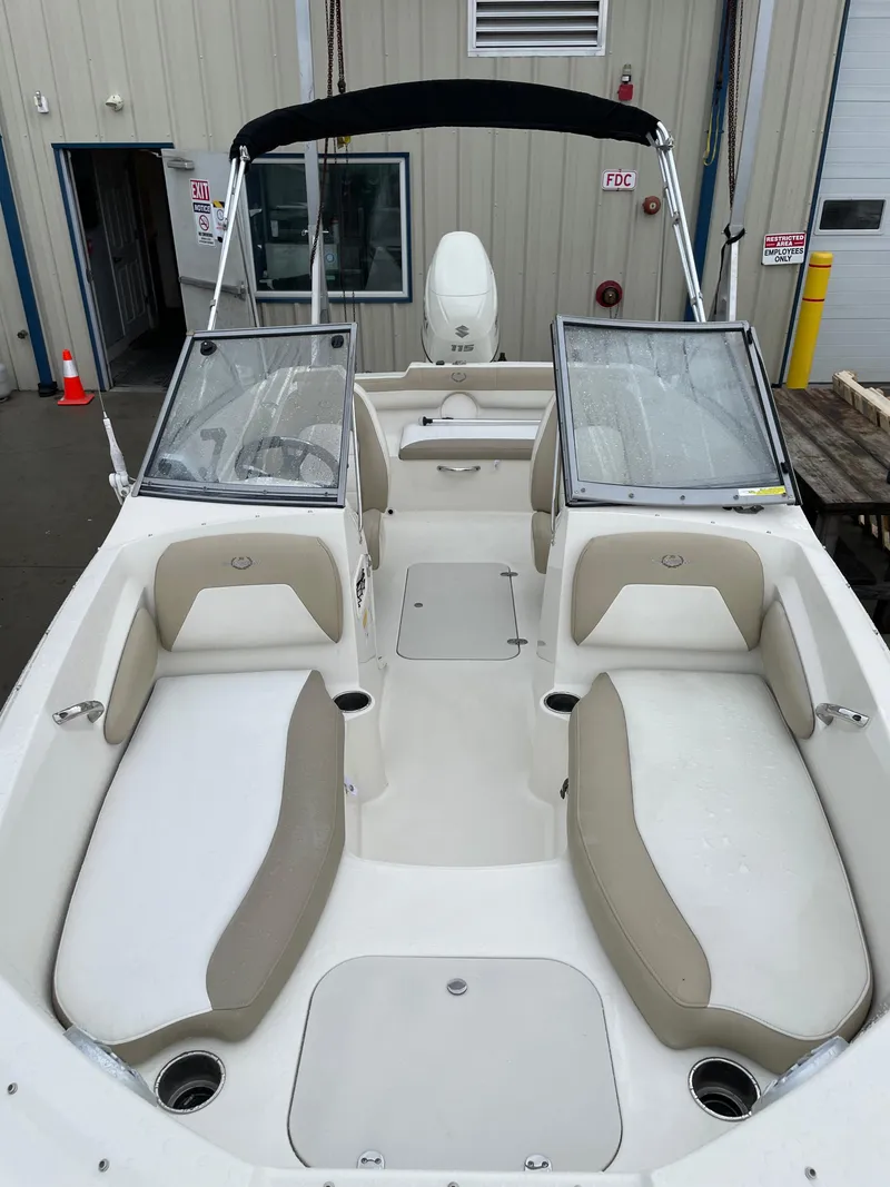 Slide: The Image of 2017 Stingray 191 DC boat interior with beige seating and dual windshields. - 4