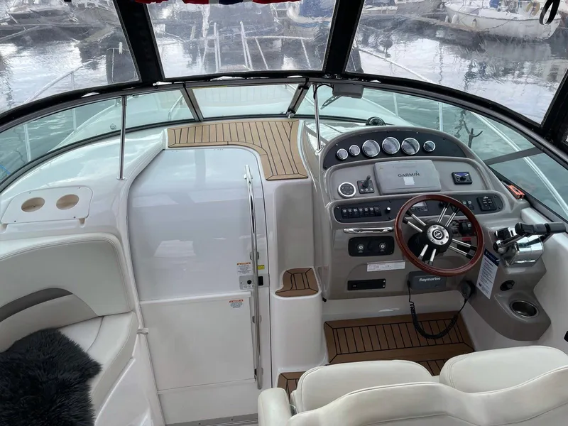 Slide: The Image of 2008 Chaparral 310 Signature boat cockpit with steering wheel and control panel. - 11