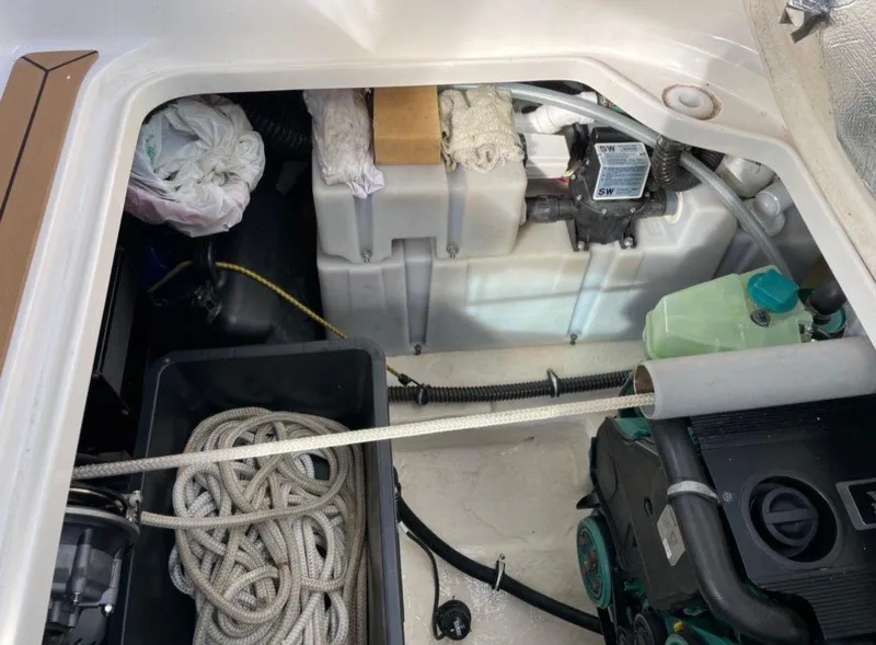 Slide: The Image of Engine compartment of a 2008 Chaparral 310 Signature boat with ropes and equipment. - 15