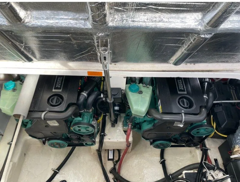 Slide: The Image of Engine compartment of a 2008 Chaparral 310 Signature boat, featuring dual engines. - 16